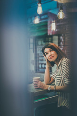 Portrait of a girl in the interior of a cafe with a Cup of coffee. Morning Breakfast in a coffee shop.