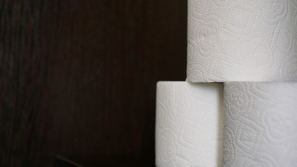 Toilet paper is consider a must item during crisis. Tissue rolls on dark background for copyspace