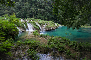 Naklejka na ściany i meble Paradise remote jungle waterfalls of semuc champey fresh turquoise clear water lush green rainforest