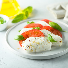 Homemade Caprese salad with fresh basil and mozzarella cheese