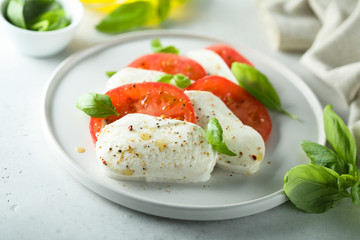 Homemade Caprese salad with fresh basil and mozzarella cheese