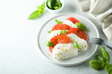 Homemade Caprese salad with fresh basil and mozzarella cheese