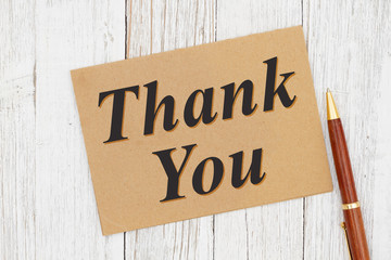 Thank you greeting card with a pen on weathered whitewash wood