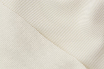 Fototapeta na wymiar Corduroy background in close up. Texture of cream corduroy textile - useful as background
