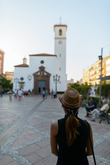 Rear view of young Asian tourist woman visiting the church