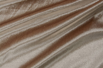 Fototapeta na wymiar Monochrome light brown soft velvet. Close up texture of the fabric is useful as a background. 