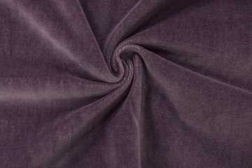 Corduroy lilac purple background in close up. Texture of soft corduroy textile - useful as background