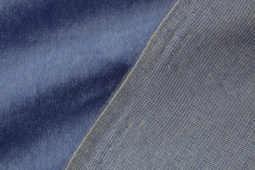 Corduroy blue background in close up. Texture of soft corduroy textile - useful as background