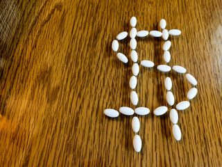 Medicine pills making dollar money sign showing expensive