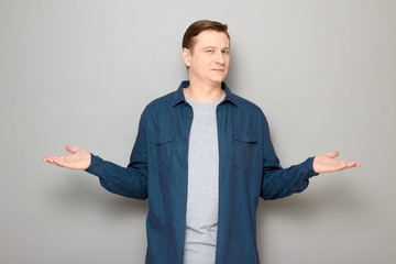 Portrait of confident friendly man raising and stretching hands