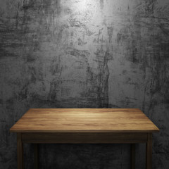 Wood table on concrete wall with light in dark background.
