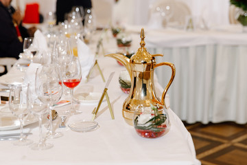 A dining table with wine glasses
