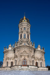 Fototapeta na wymiar Old and beautiful church in winter against the sky