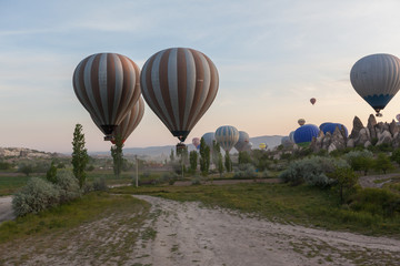 Cappadocia, Turkey : Hot air ballooning start over fairy chimneys valley sunrise 