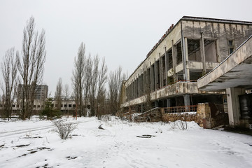 Fototapeta na wymiar Abandoned ghost town Prypiat. Overgrown trees and collapsing buildings. Pripyat, Chornobyl exclusion zone. December 2016