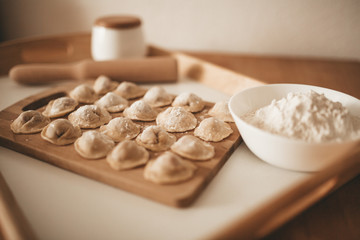 Raw dumpling with meat. Preparation dumplings on a wooden board.