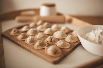 Obraz na płótnie Canvas Raw dumpling with meat. Preparation dumplings on a wooden board.