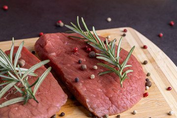 fresh raw sliced beef meat steak on a wooden board