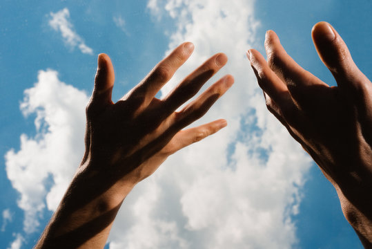 Close Up Of Hands Against Cloudy Sky