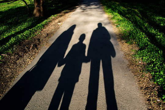 Family Shadow On The Pavement In The Park