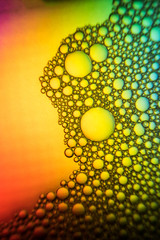Close up of the Colorful bubbles on a green, yellow, red background.