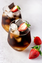 Glasses of Homemade Cold Brew Coffee to Drink for Breakfast Summer Beverage with Ice Cubes Decorated with Strawberry and Chocolate Vertical