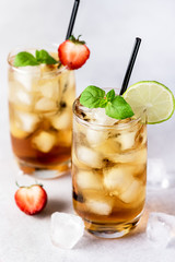 Glasses of Cold Citrus and Strawberry Ice Tea Decorated with Slice of Lemon and Strawberry Healthy Summer Drink Vertical
