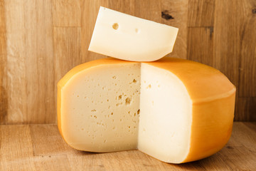 block of cheese on wood background 