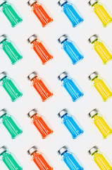 Various medical vials with colored liquid.