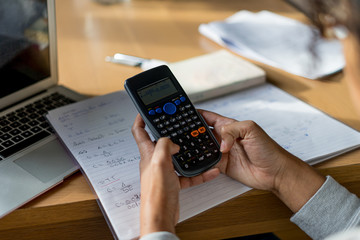 Smart person doing math on a calculator