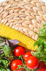 Raw vegetables close up. Vegetables on table against background of white wall. view of fresh tomatoes, basil, eggplant, red pepper and corn. Healthy eating concept. Selective focus image.