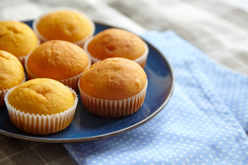 Pumpkin muffins on blue plate, selective focus. Homemade bakery, plant-based food