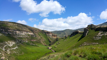 Fluffy clouds over rock formations in the Golden Gate Highlands National Park, Clarens, Free State, South Africa