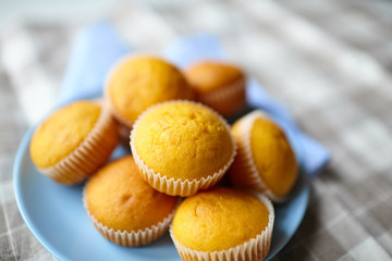 Pumpkin muffins on blue plate on table with tablecloth