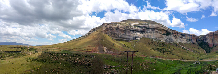 Fluffy clouds over rock formations in the Golden Gate Highlands National Park, Clarens, Free State,...