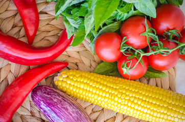 Raw vegetables close up. Top view of fresh tomatoes, basil, eggplant, red pepper and corn. Healthy eating concept, vegetable background. Selective focus image, flat lay.