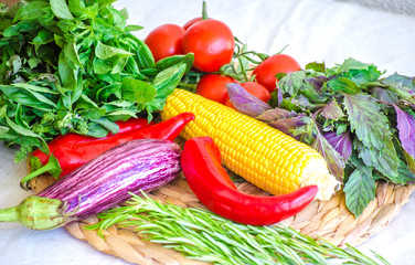 Raw vegetables close up. Top view of fresh tomatoes, basil, eggplant, red pepper and corn. Healthy eating concept, vegetable background. Selective focus image, flat lay.