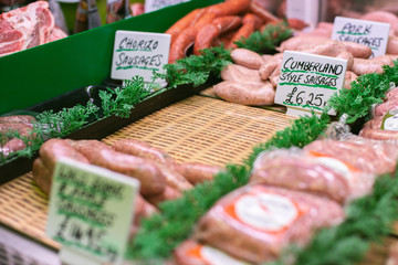 A selection of high-welfare meat sausages on display in a butchers store