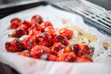 Roasted cherry tomatoes sit in a tray waiting to be served