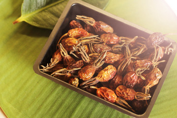 Dried rose hips in a black bowl