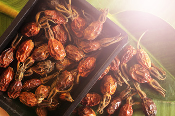 Dried rose hips in a black bowl