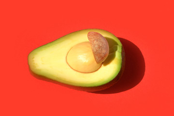 half of fresh avocado. Pop art design, creative concept of summer and healthy food.