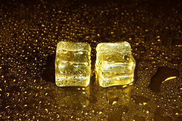 ice cubes on a reflections yellow light.