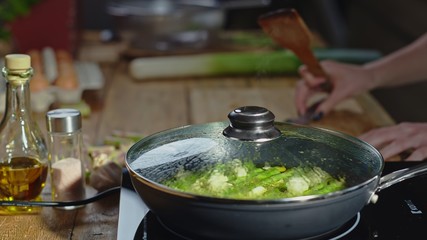 Real authentic cooking in kitchen - aspargus in frying pan