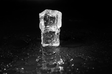 ice cubes on black table background.