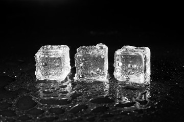 ice cubes on black table background.