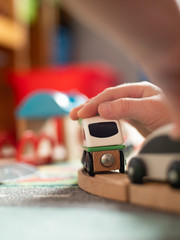 Closeup of toddler playing with toy train. games at home during self-isolation