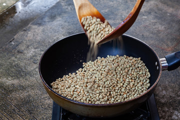 Traditional roasting coffee at home,  freshly roasted coffee beans.