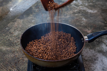 Traditional roasting coffee at home,  freshly roasted coffee beans.
