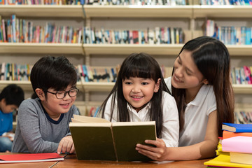 Fototapeta na wymiar Education image,asian children happy learning in library at school.